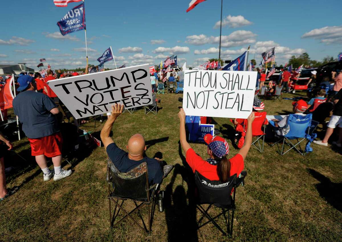 Trump supporters hold up signs as Congressmen Kevin Brady, R-The Woodlands, addresses a crowd of several hundred people during a “Defend Our President” rally at the Montgomery County Fairgrounds, Saturday, Nov. 7, 2020, in Conroe.