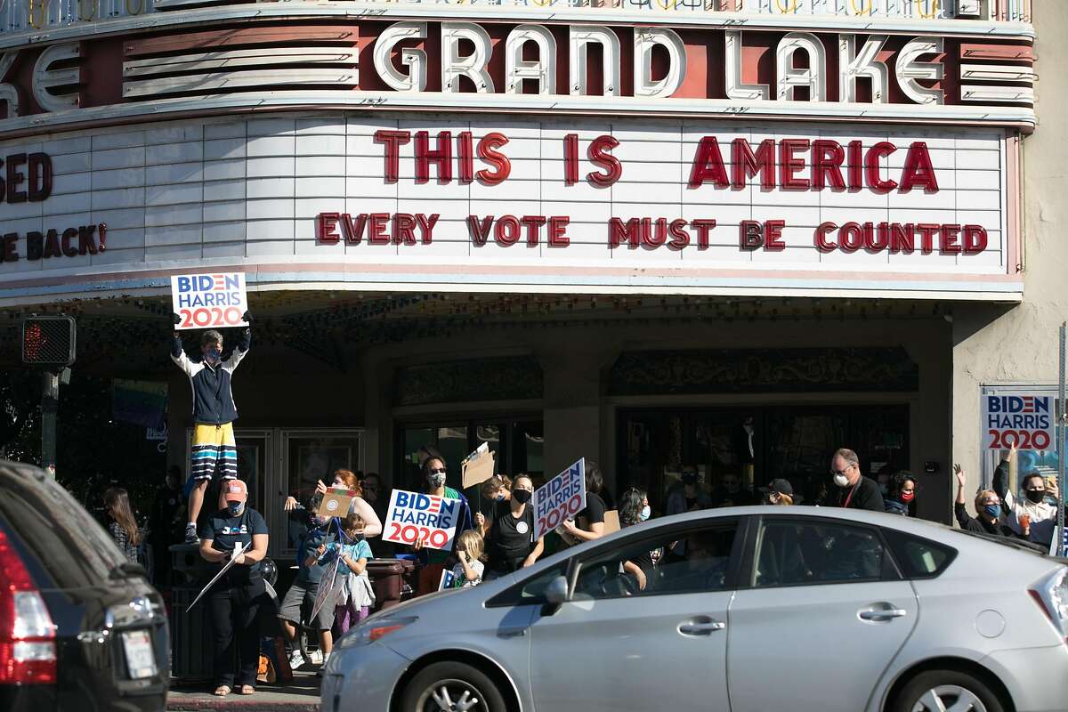 Supporters of Democratic presidential candidate Joe Biden celebrate his victory over President Donald Trump in Oakland, Calif., on Nov. 7, 2020, in front of the Grand Lake Theater.