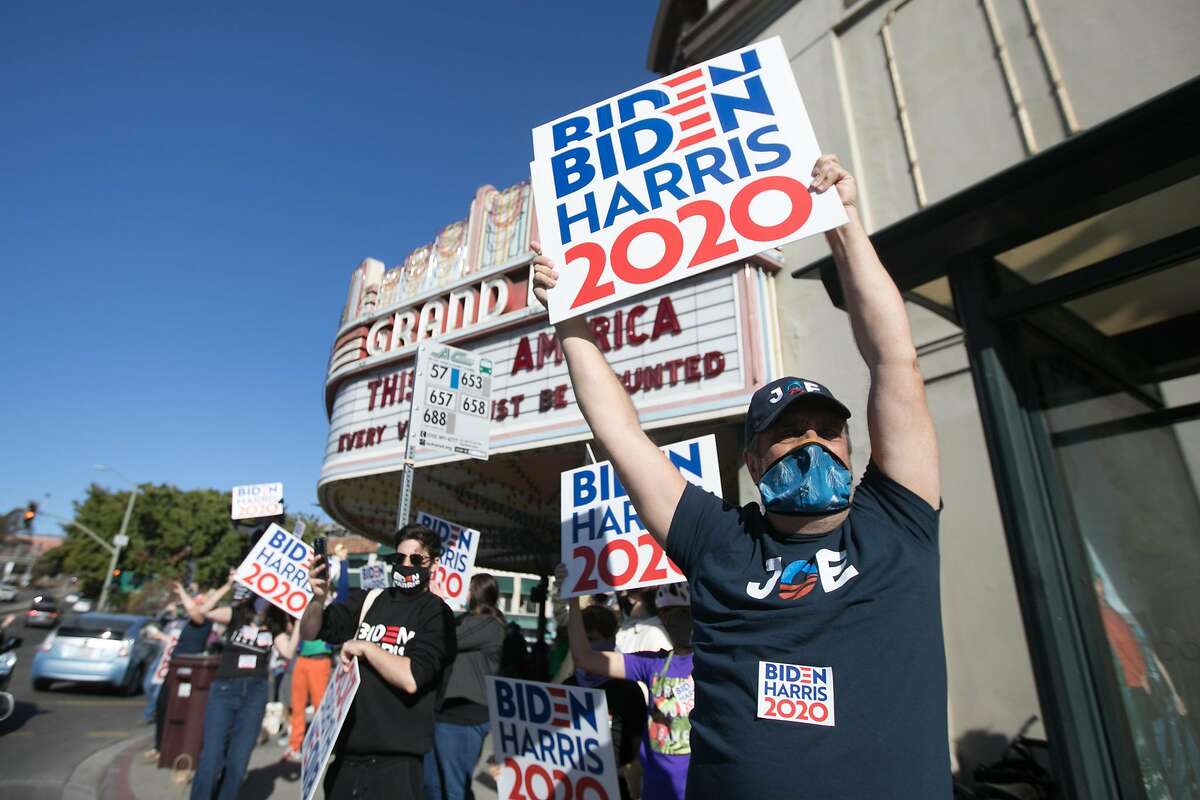 Supporters of Democratic Presidential candidate Joe Biden celebrate his victory over President Donald Trump in Oakland, California on Nov. 7, 2020 outside the Grand Lake Theater.