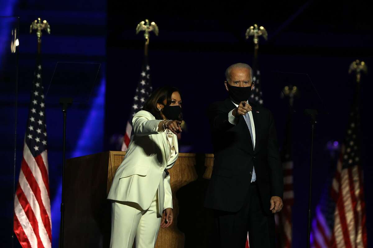President-elect Joe Biden and Vice President-elect Kamala Harris greet the crowd at the Chase Center November 07, 2020 in Wilmington, Delaware. After four days of counting the high volume of mail-in ballots in key battleground states due to the coronavirus pandemic, the race was called for Biden after a contentious election battle against incumbent Republican President Donald Trump.