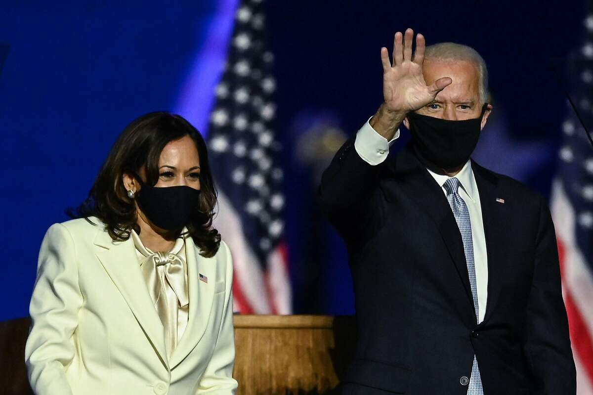 US President-elect Joe Biden (R) arrives next to Vice President-elect Kamala Harris to deliver remarks in Wilmington, Delaware, on November 7, 2020, after being declared the winners of the presidential election.