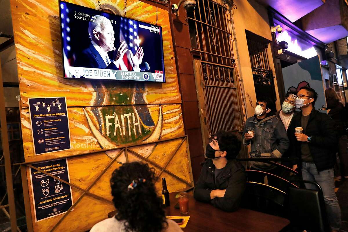Diners at Puerto Alegre on Valencia Street listen to US President-elect Joe Biden give his victory speech on a television screen in San Francisco, Calif., on Saturday, November 7, 2020.
