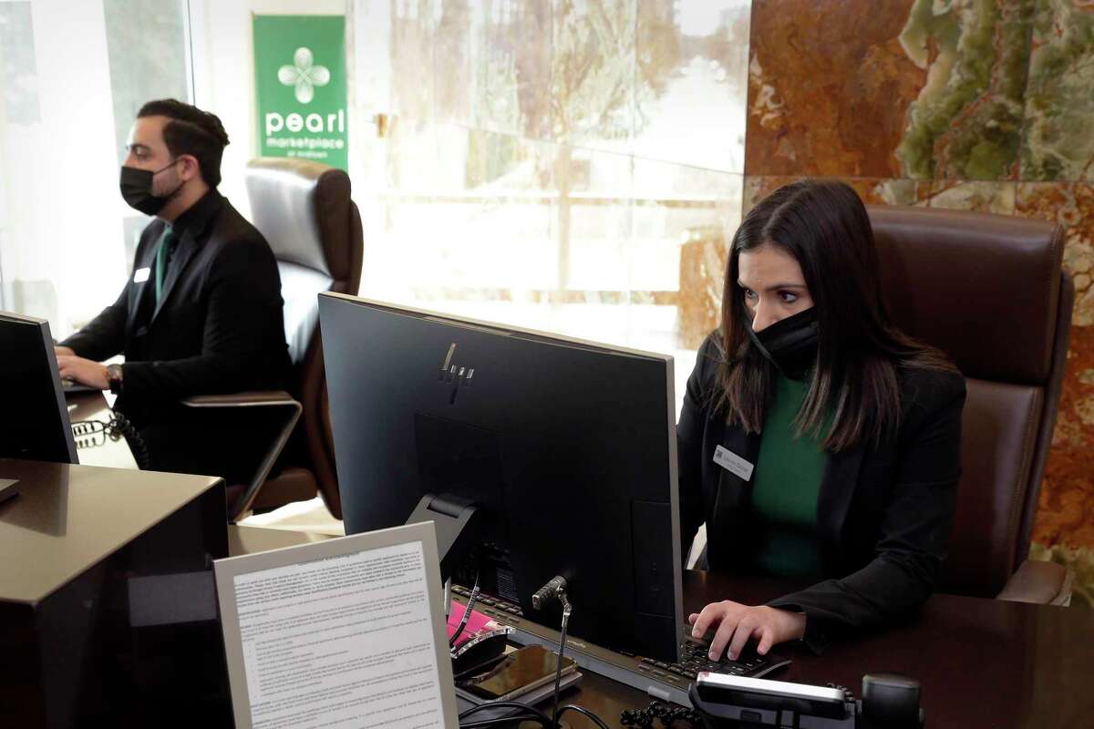 Adrian Martinez, left, and Lauren DeJoe work in the leasing office at the Pearl Marketplace, part of the Morgan Group.