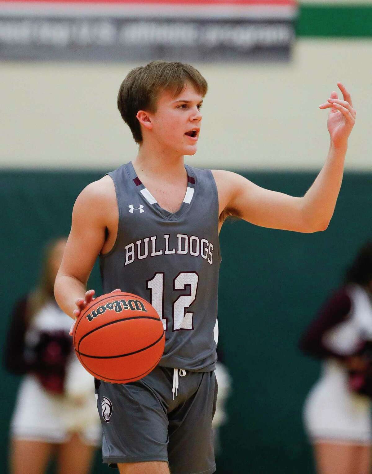 Magnolia shooting guard Andrew Bauer (12) motions to players during the second quarter of a Region III-5A bi-district high school playoff game at The Woodlands High School, Tuesday, Feb. 25, 2020, in The Woodlands.