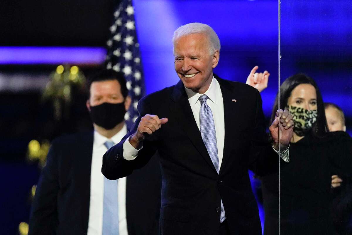President-elect Joe Biden reacts as he stands on stage after speaking Saturday, Nov. 7, 2020, in Wilmington, Del.
