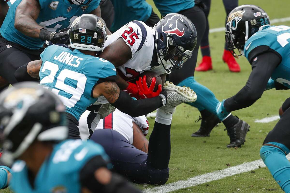 Houston Texans running back Duke Johnson (25) dives into the end zone past Jacksonville Jaguars cornerback D.J. Hayden (25) for a 1-yard touchdown run during the first half of an NFL football game at TIAA Bank Field Sunday, Nov. 8, 2020, in Jacksonville.