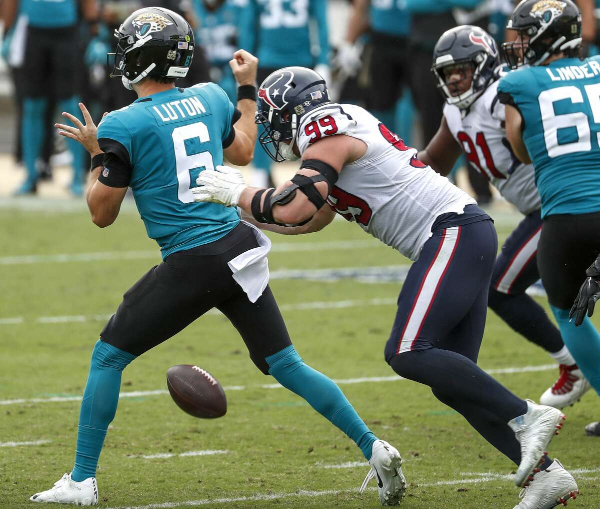 Houston Texans defensive end J.J. Watt (99) strips the ball away from Jacksonville Jaguars quarterback Jake Luton (6) as he sacks the quarterback during the second half of an NFL football game at TIAA Bank Field Sunday, Nov. 8, 2020, in Jacksonville. The sack was Watt's 100th career sack.