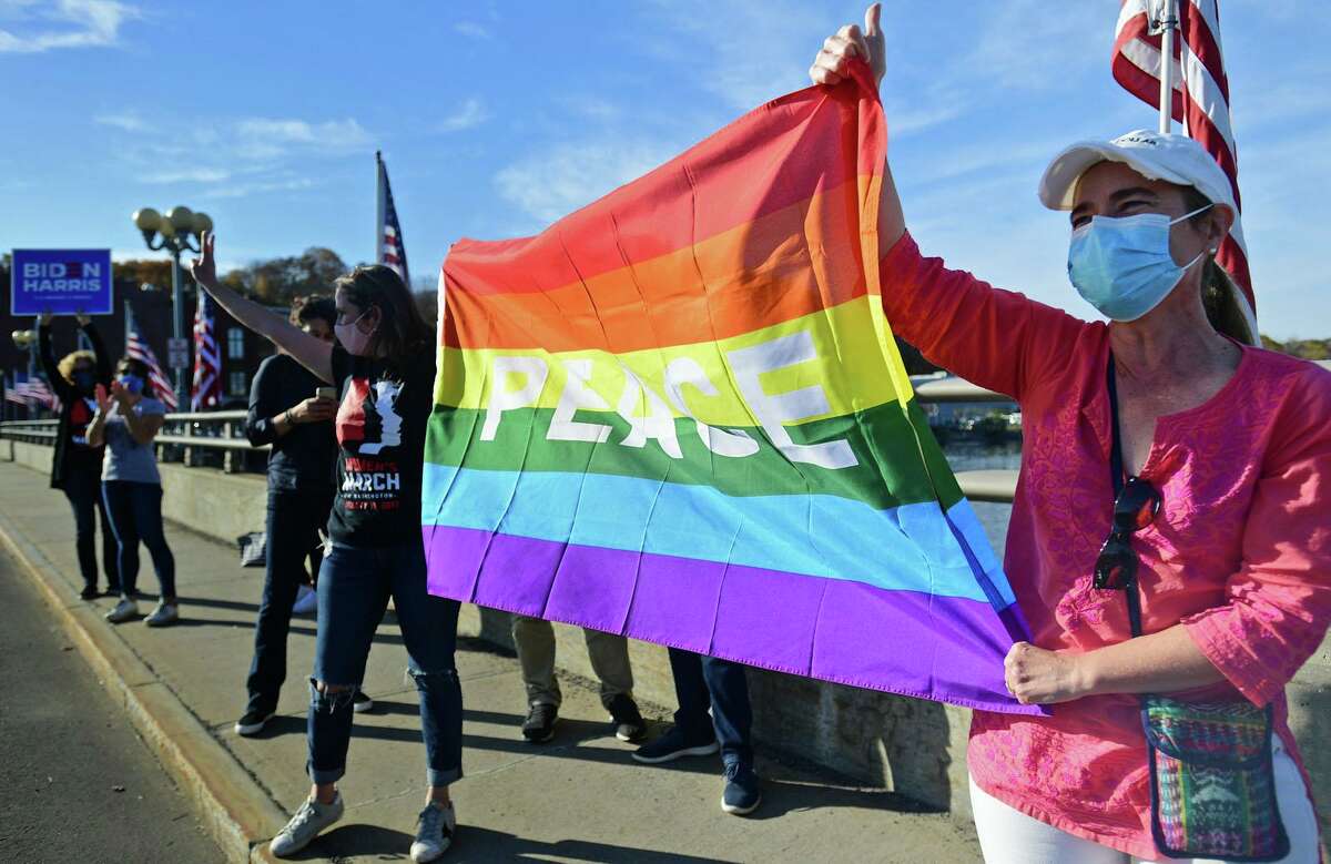 Local residents gather at the Ruth Steinkraus bridge in downtown Westport to celebrate the Biden-Harris declaration of victory in the US presidential election Saturday, November 7, 2020, in Westport, Conn.
