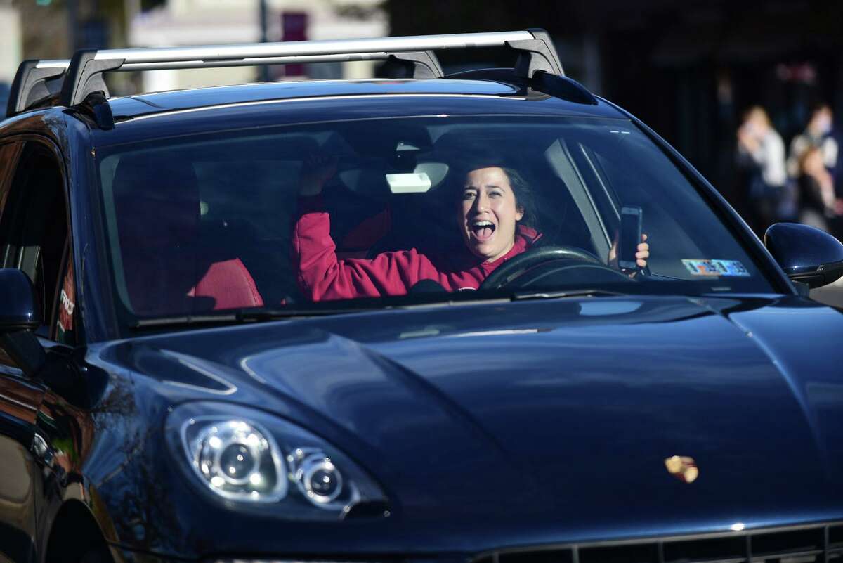 Local residents gather at the Ruth Steinkraus bridge in downtown Westport to celebrate the Biden-Harris declaration of victory in the US presidential election Saturday, November 7, 2020, in Westport, Conn.