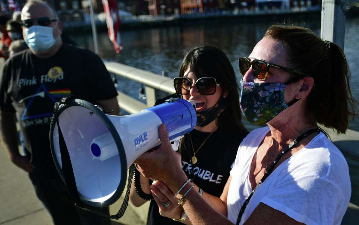 Local residents including Darcy Hicks gather at the Ruth Steinkraus bridge in downtown Westport to celebrate the Biden-Harris declaration of victory in the US presidential election Saturday, November 7, 2020, in Westport, Conn.
