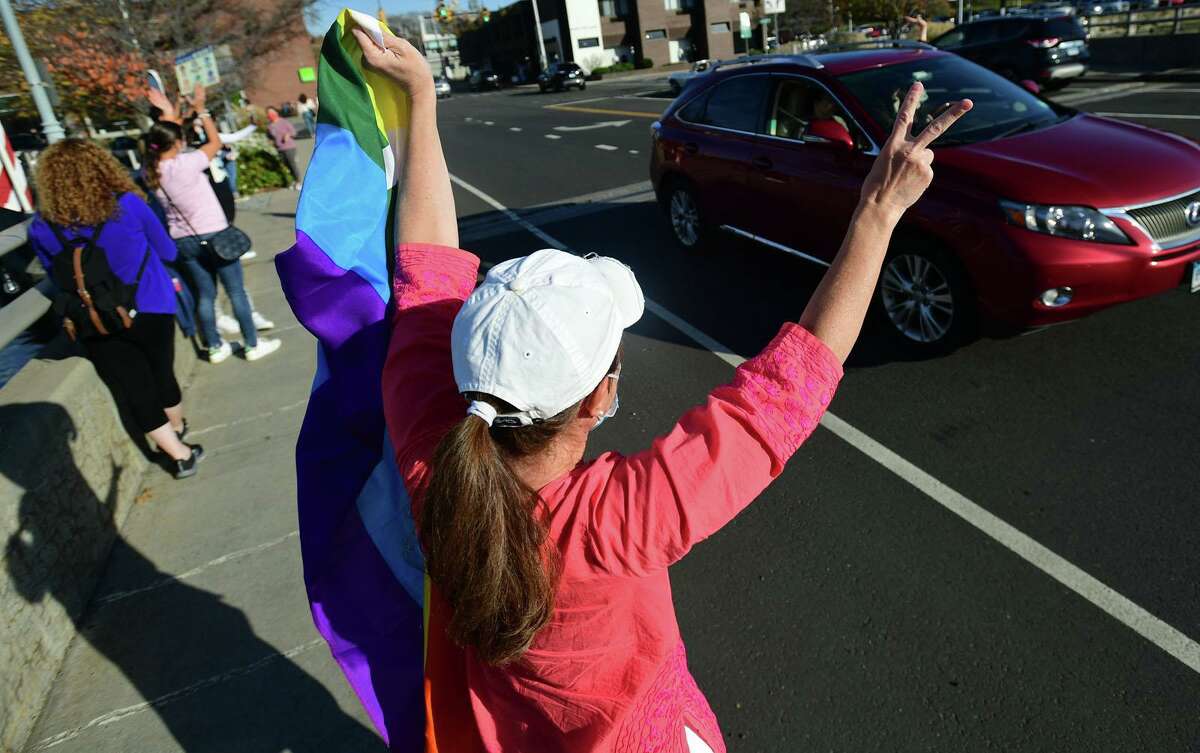 Local residents gather at the Ruth Steinkraus bridge in downtown Westport to celebrate the Biden-Harris declaration of victory in the US presidential election Saturday, November 7, 2020, in Westport, Conn.