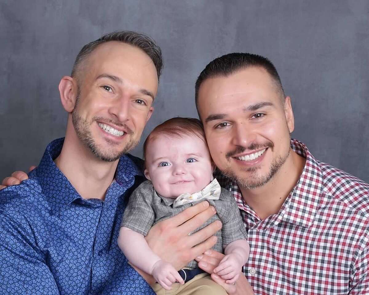 Eric MacDowell, left, and Eric Wilke with their son, Xander, who they adopted through Friends in Adoption.