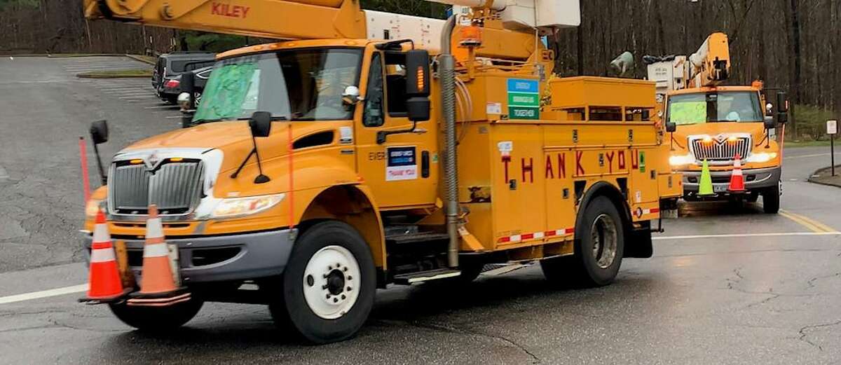 A contingent of Eversource utility company workers conduct a thank you salute during the coronavirus in Connecticut this past pring. The utility company has submitted its proposed electricity prices for the coming winter to the Connecticut Public Utilities Regulatory Authority for approval.