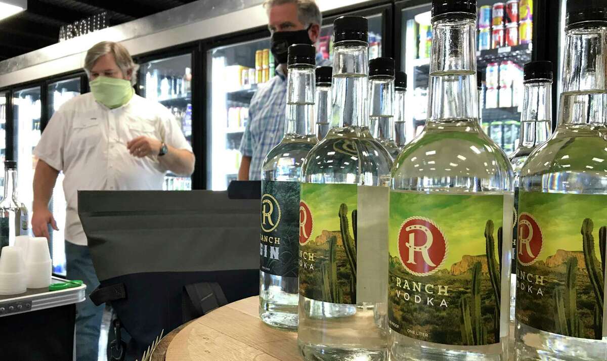 Chris Ware (left) and West Stone offer tastings of their Ranch Vodka during a recent event at Alamo City Liquor.