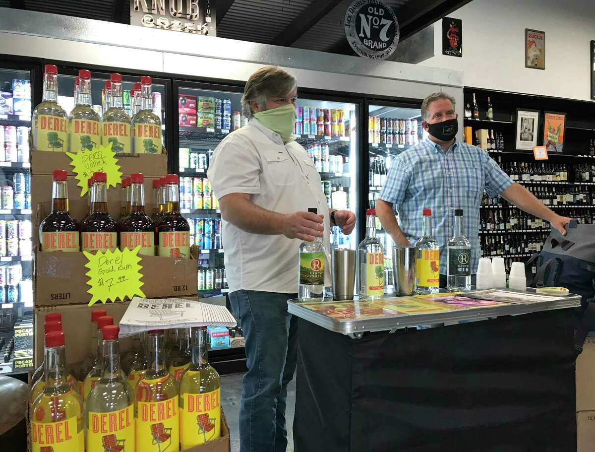 Chris Ware (left) and West Stone offer tastings of their Ranch Vodka during a recent event at Alamo City Liquor.