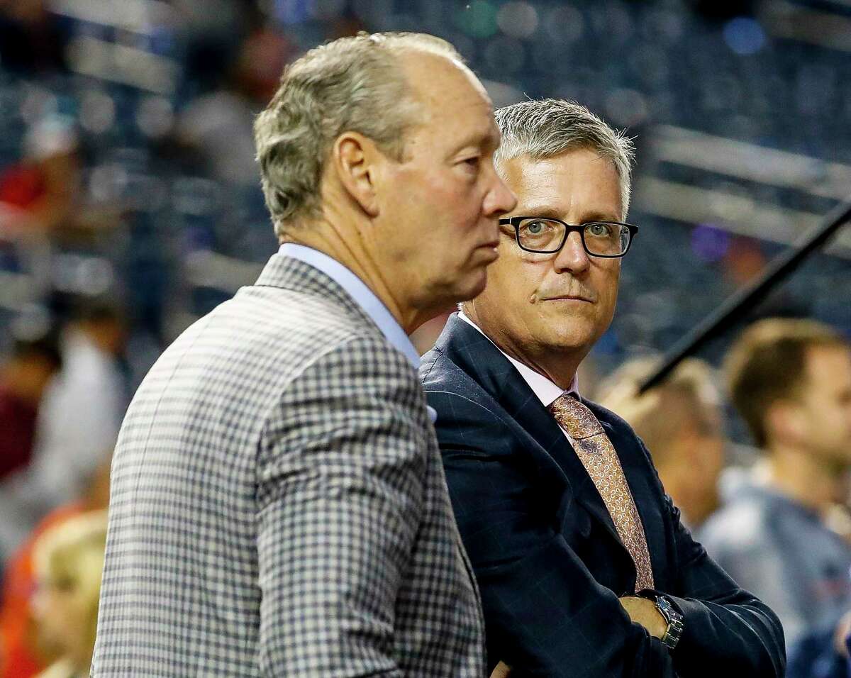 In a lawsuit filed Monday, former Astros general manager Jeff Luhnow, right, alleges that his firing by team owner Jim Crane denied him benefits that include $22 million of his $31 million contract plus bonuses and a guaranteed slice of the ballclub’s profits.