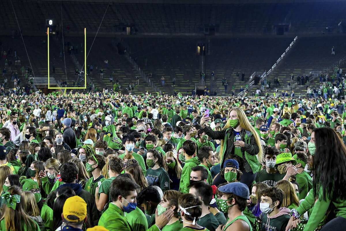 Fans storm the field after Notre Dame defeated Clemson 47-40 in two overtimes in South Bend, Ind., on Nov. 7.