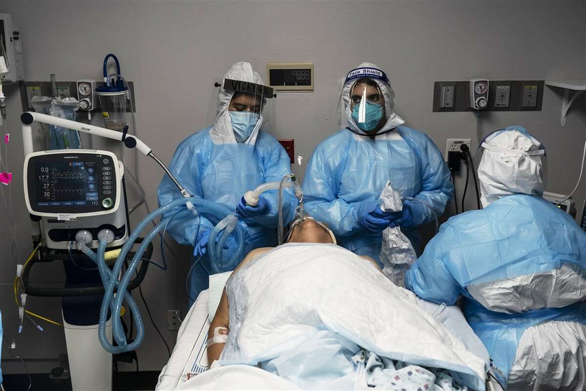 Medical workers treat a patient with COVID-19 in the intensive care unit at United Memorial Medical Center in Houston on Oct. 31.