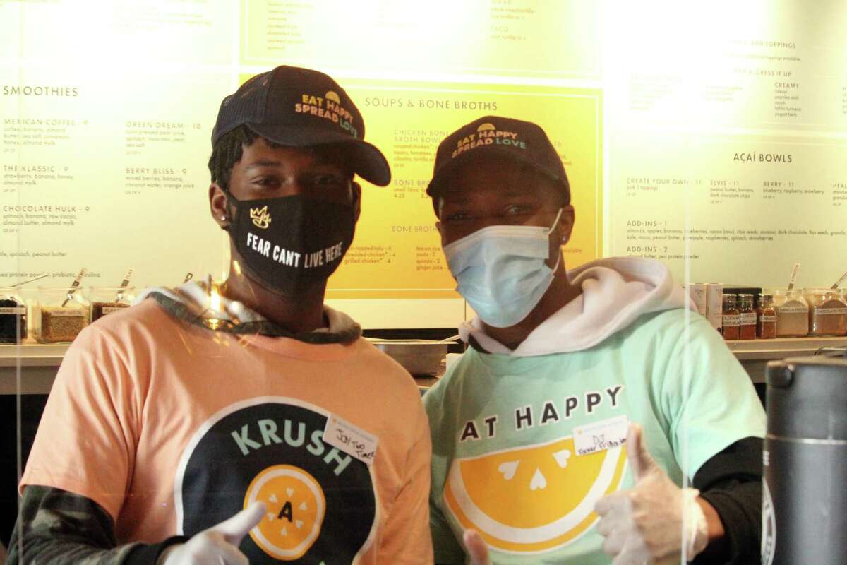 Organic Krush employees Jaden Dupree, a Stamford resident, and DJ Elliott, a Stamford resident, celebrate the store's opening. Taken Nov. 2, 2020 in Westport, Conn. While COVID-19 has impacted the restaurant industry, Walrath said their experience managing other locations throughout the pandemic has helped them open the new business. All of their locations have remained open while also helping to serve hospitals, domestic violence shelters and other community organizations.
