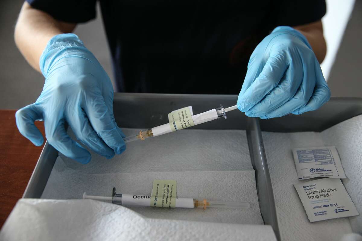 A health care worker holds an injection syringe of the phase 3 vaccine trial, developed against the novel coronavirus (COVID-19) pandemic by the U.S. Pfizer and German BioNTech company, at the Ankara University Ibni Sina Hospital in Ankara, Turkey on October 27, 2020.