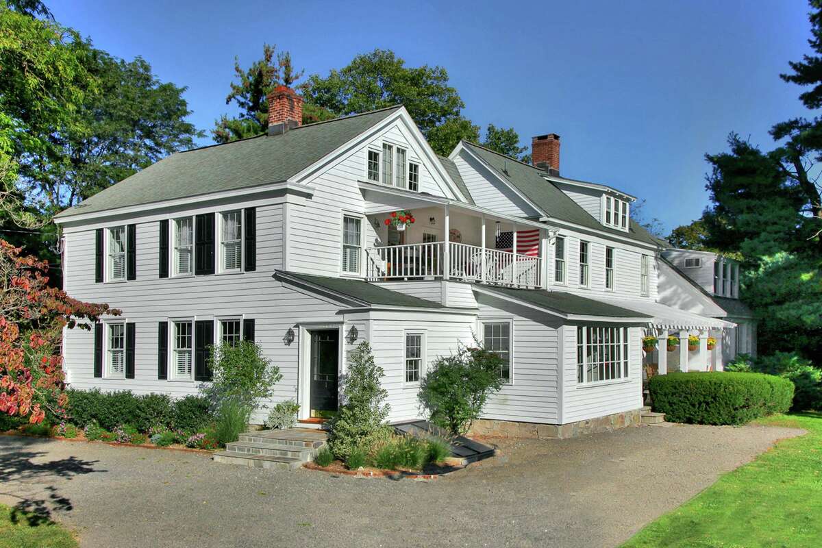 The the antique colonial house at 1 Compo Beach Road sits across from Westport's historic Minute Man statue. More than two centuries later the residents of the Compo Beach neighborhood have that landmark as a constant reminder of the cost of freedom, and they are able to pay tribute to those whose fight gave them the life they are able to lead today. This waterfront community provides its residents a wealth of leisure and recreation, including athletic and entertaining venues and casually elegant living spaces. This white house with black shutters was built in 1845, only 78 years after the local Minute Men fought with British troops returning to their ships after raiding Danbury. The house, which sits on a 0.63-acre level property is only about a three-minute walk from Compo Beach, Ned Dimes Marina and Longshore Club Park, the latter of which has a number of amenities including an 18-hole golf course, flagship restaurant, tennis courts, swimming pool, marina and sailing school.