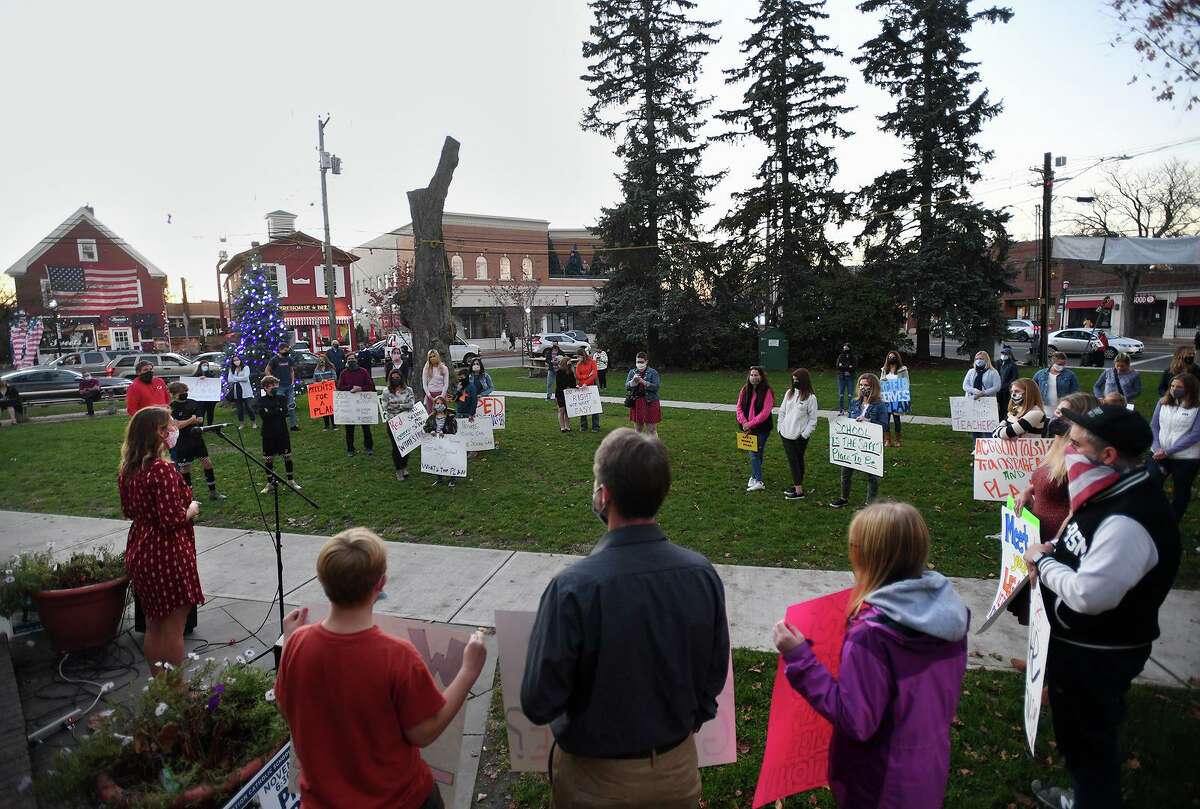 Parents pressing for a full time return to the classroom for Fairfield students rally on Sherman Green in Fairfield, Conn. on Monday, November 9, 2020.