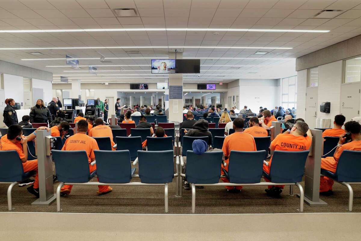 Detainees and inmates wait in the waiting room for various court and other processing events in the waiting room of the Harris County Joint Processing Center Thursday, March 5, 2020 in Houston.