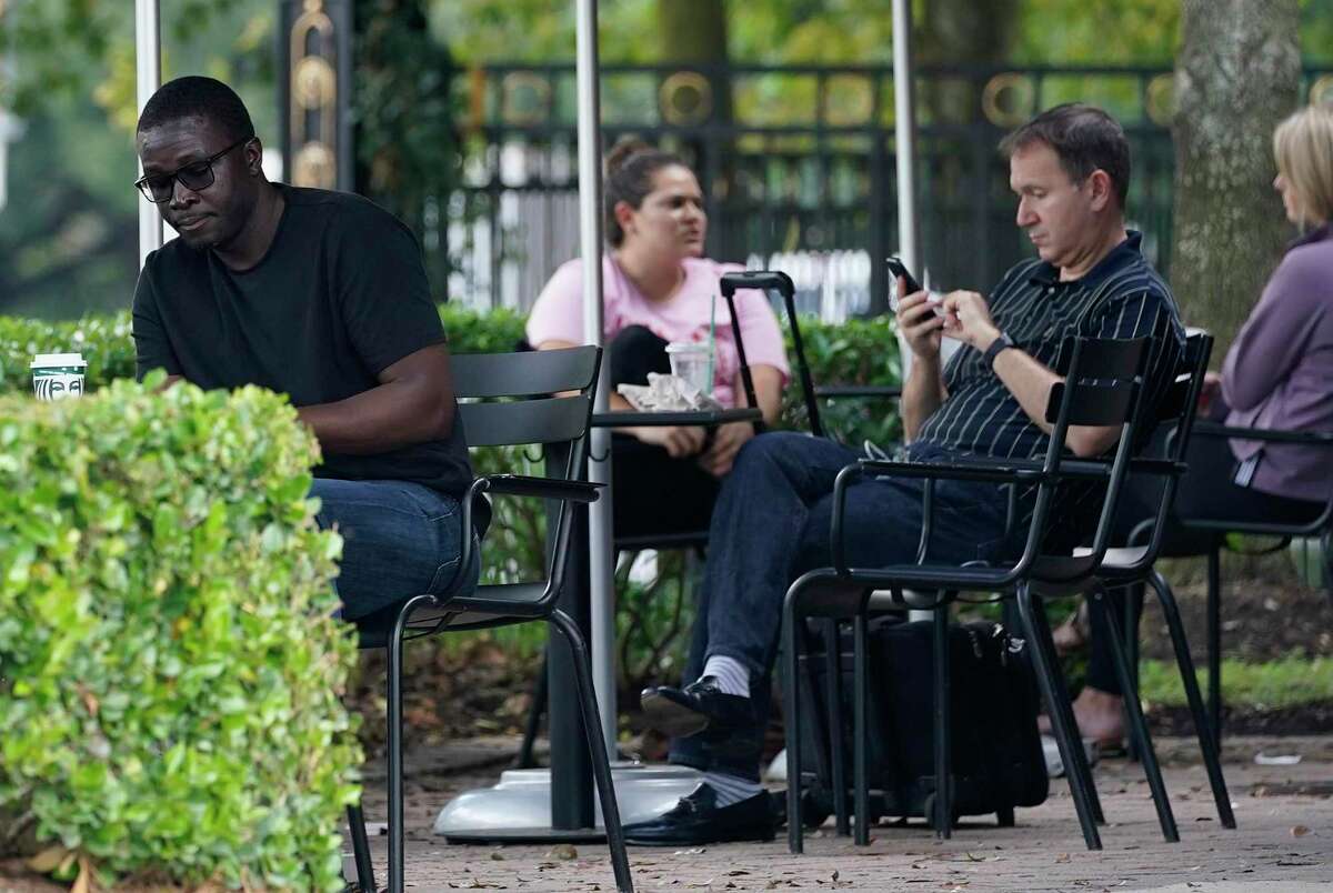 People sit outside in the Memorial area amid the COVID-19 pandemic Tuesday, Nov. 10, 2020 in Houston. Texas has reached more than 1 million cases of COVID-19, making it the first state in the country to pass this milestone.