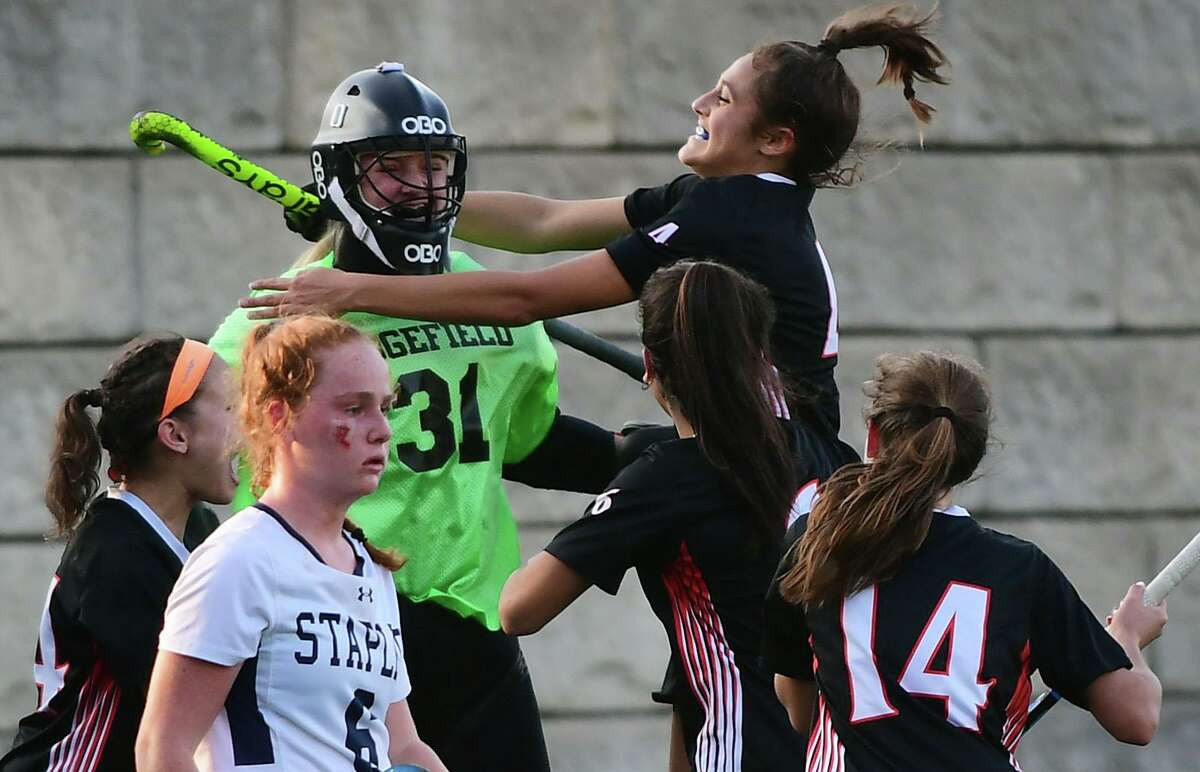 Ridgefield celebrates after beating Staples High School in their FCIAC Central field hockey championship game Tuesday, Novemver 10, 2020, in Westport, Conn.