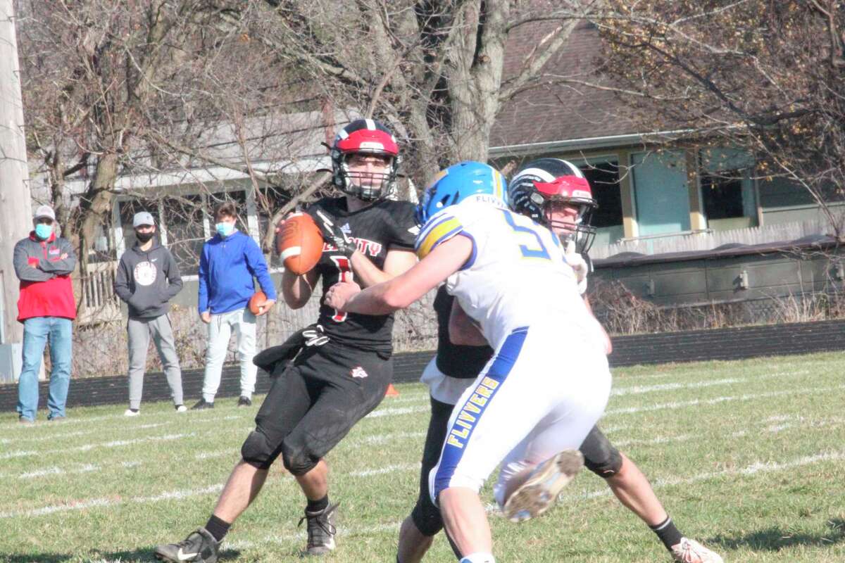 Reed City quarterback Isaac Williams looks for a receiver against Kingsford on Saturday. (Herald Review photo/John Raffel)