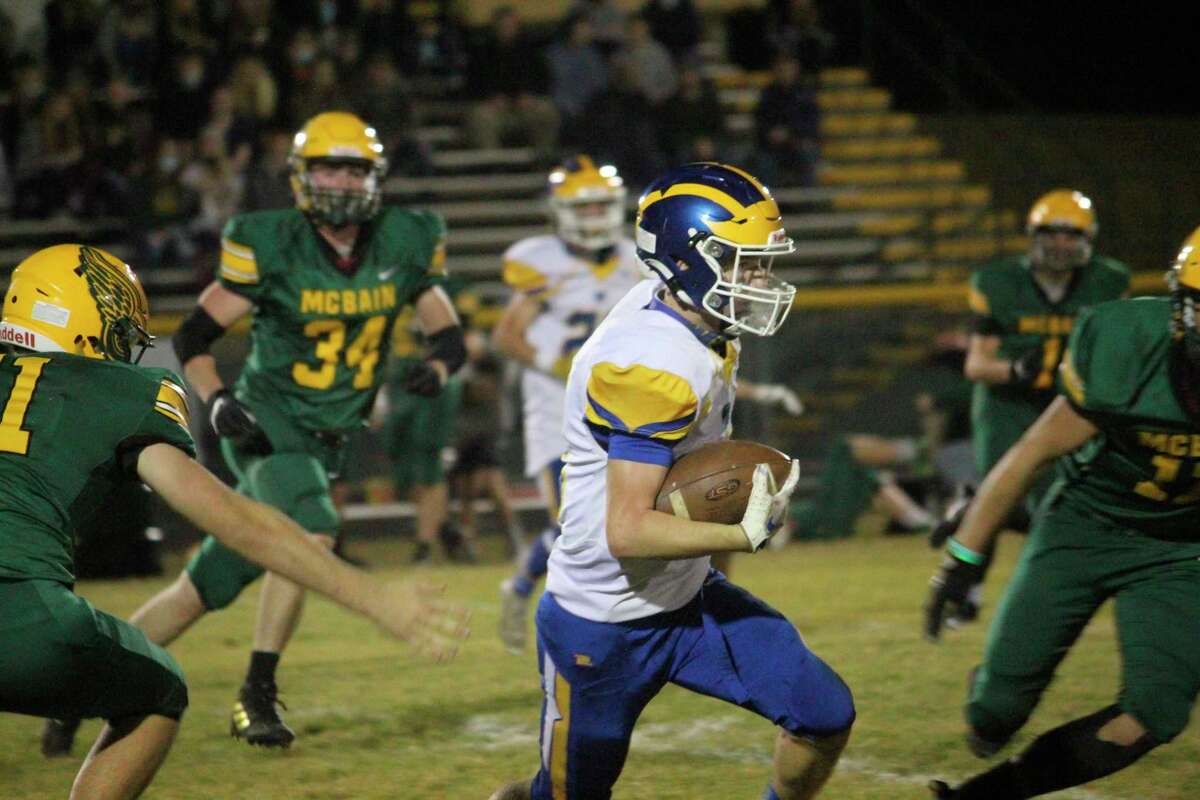 Evart quarterback Danny Witbeck looks for running room against McBain on Friday. (Herald Review/John Raffel)
