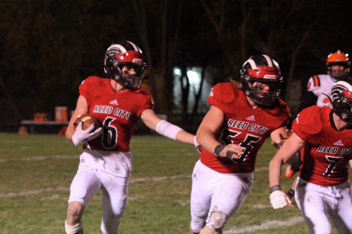 Reed City's Landon Tomaski (6) gets blocking support from teammate Teddy Cross in Friday's playoff game vs. Cheboygan on Oct. 30. (Herald Review photo/John Raffel) Attachments area