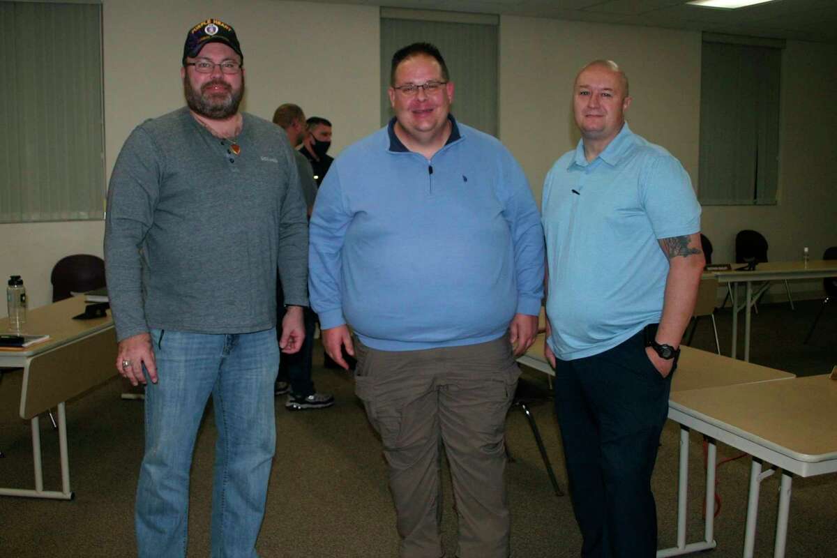 Newly elected Mayor Roger Meinert (center) welcomes newly elected council members Russ Nehmer (far left) and Brad Nixon (far right) at the council meeting Nov. 9. Nehmer and Nixon were sworn in as council members earlier in the day. (Herald Review photo/Cathie Crew)