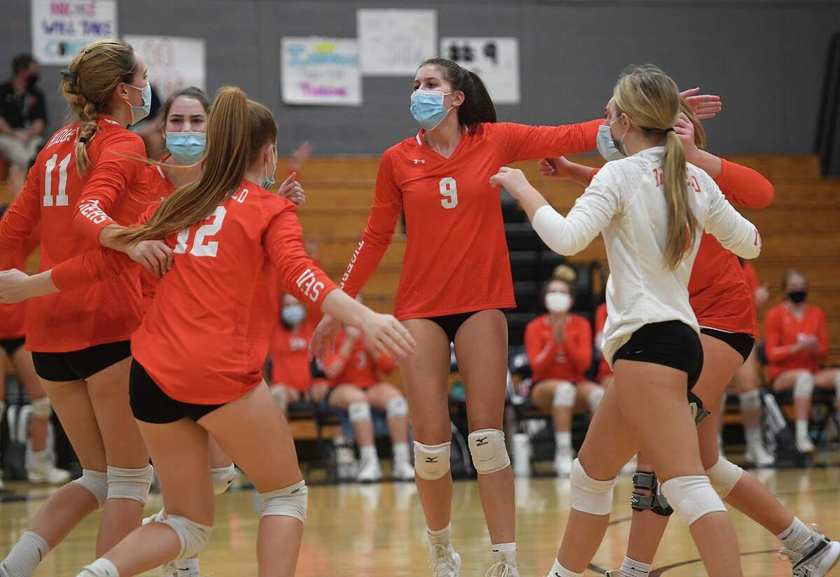 Isabel Voellmicke (#9) and her Ridgefield teammates celebrate a winning point during their 3-0 loss to Staples in the FCIAC Central volleyball championship match at Staples High School in Westport, Conn. on Tuesday, November 10, 2020.