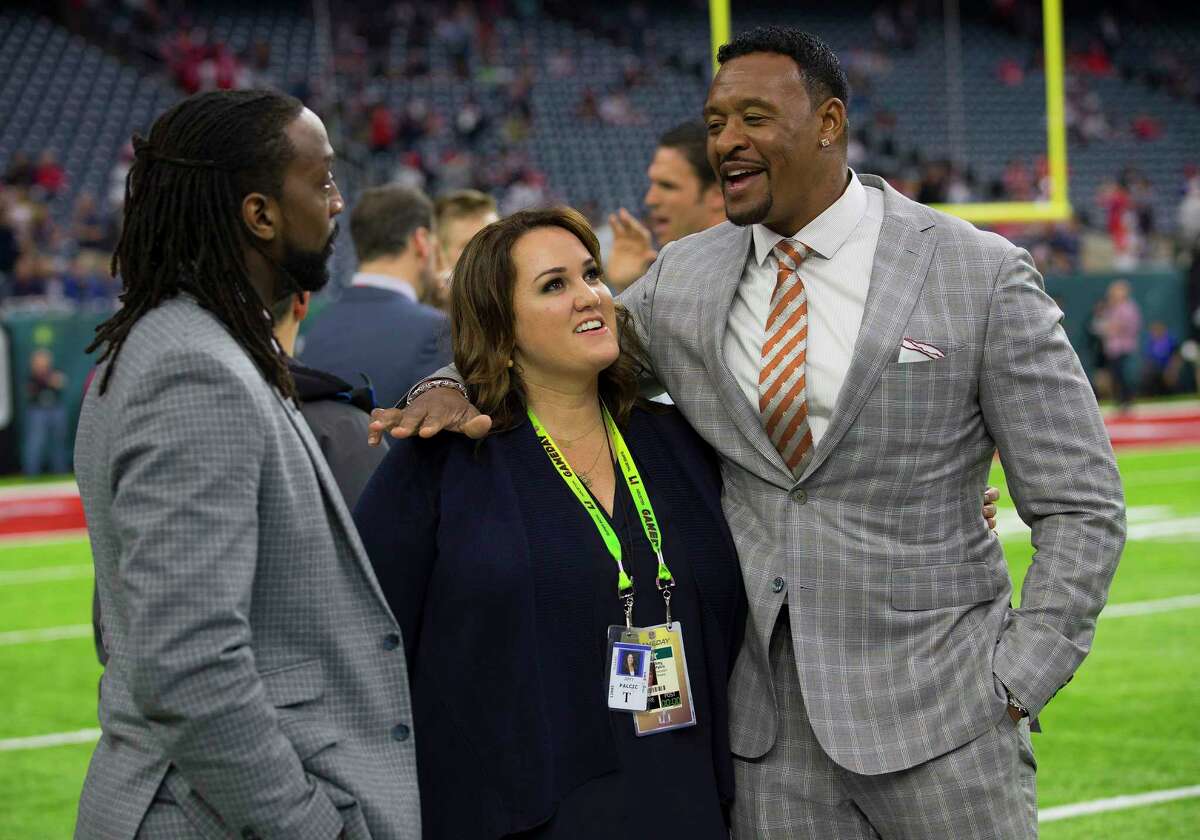 Amy Palcic, senior director of communications for the Houston Texans, center, talks to former NFL players Charles Tillman, left, and Willie McGinest before Super Bowl LI at NRG Stadium on Sunday, Feb. 5, 2017, in Houston.