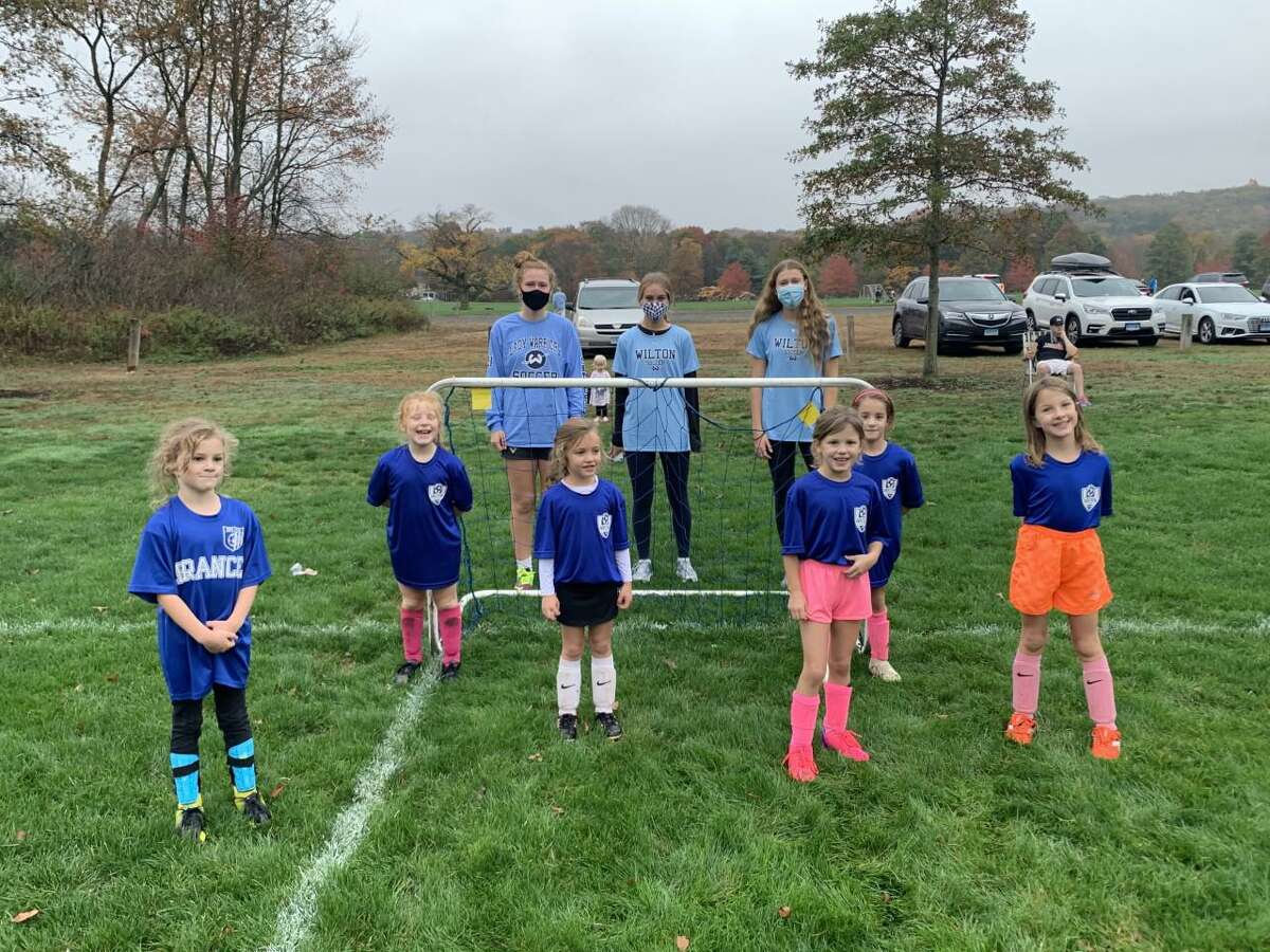Members of the Wilton High School boys and girls soccer teams visited younger players in the Wilton Soccer Association last month.