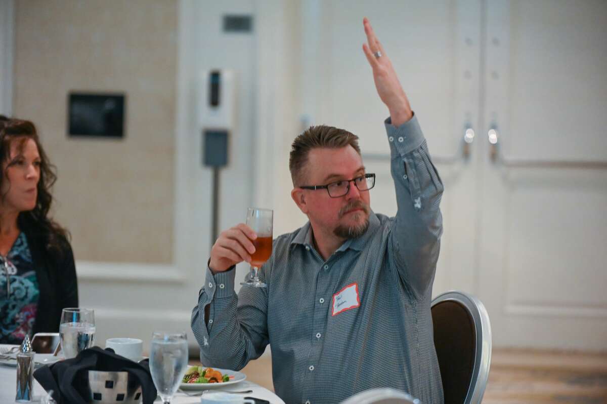 Paul Preston bids on an item during the annual "Dine on the Doors" fundraiser for Midland's Open Door Tuesday, Nov. 10, 2020 at The H Hotel in Midland. (Adam Ferman/for the Daily News)