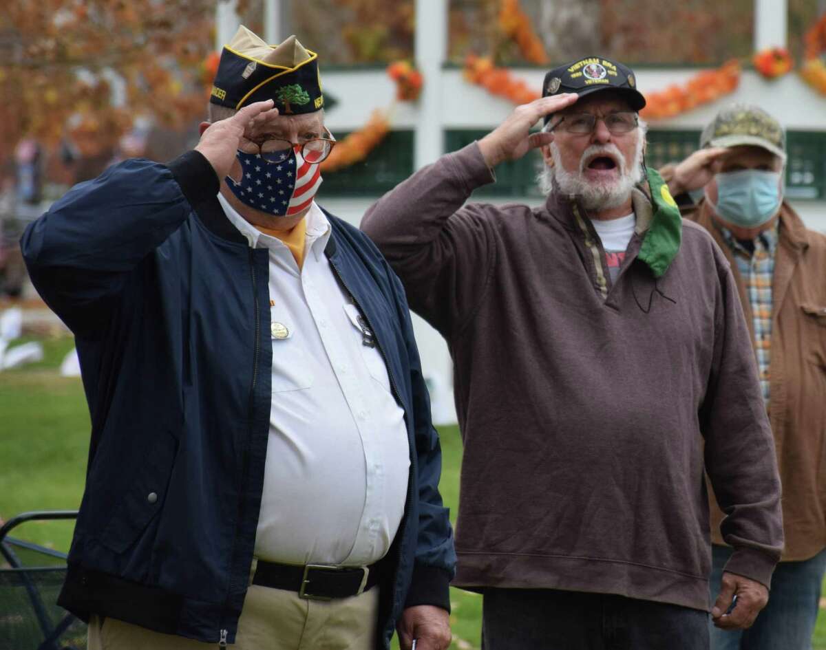 American Legion Commander Jeff McBreairty, left, and Buck Oviatt of Buck and the Buckshots offer a salute as Oviatt sings the National Anthem.