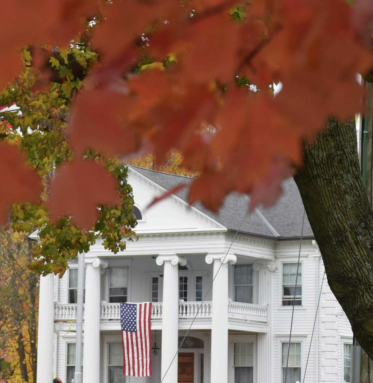 An American flag proudly hangs in front of Lillis Funeral Home, across from the Green where the ceremony was held.