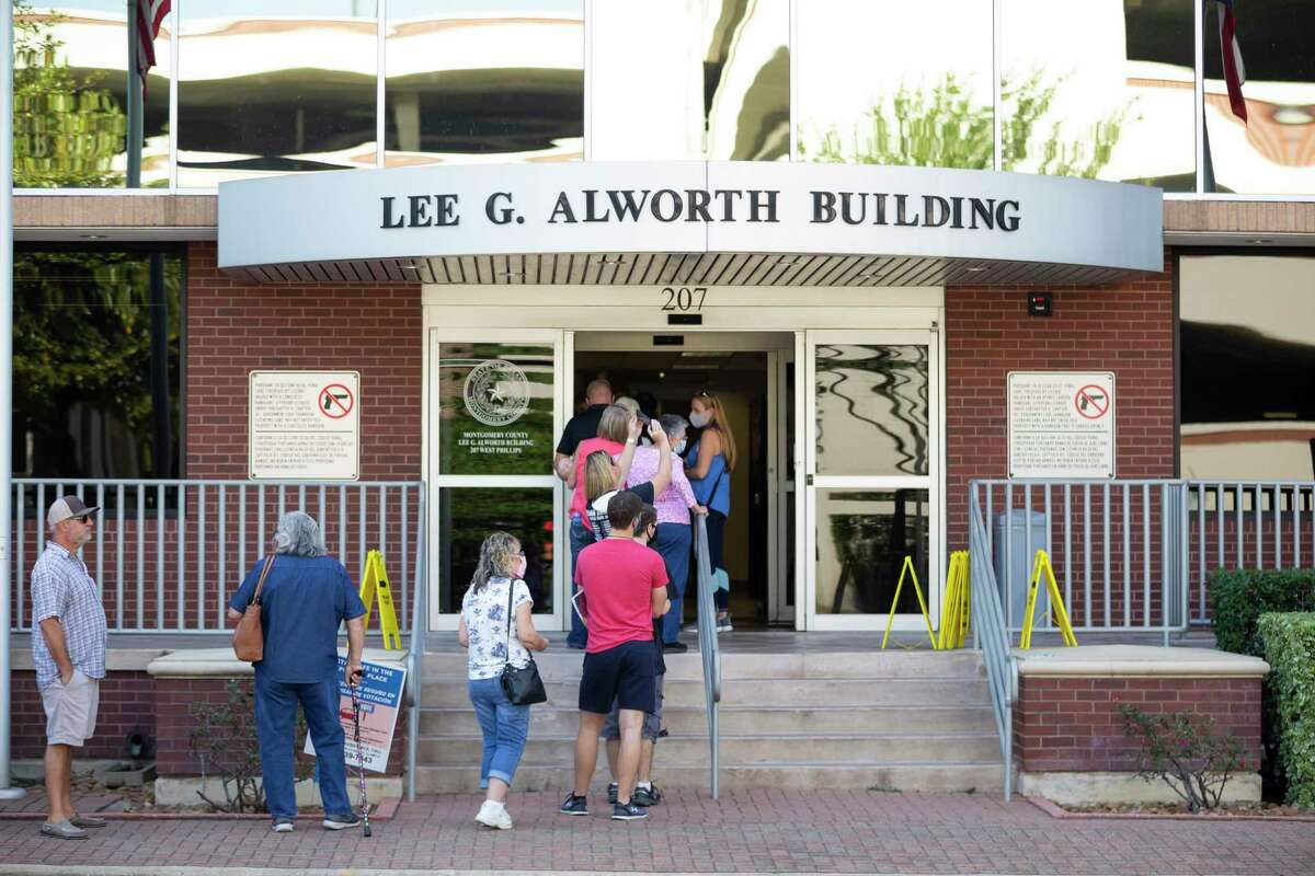 Residents wait in line outside the Lee G. Alworth Building on the first day of Early Voting, Tuesday, Oct. 13, 2020.