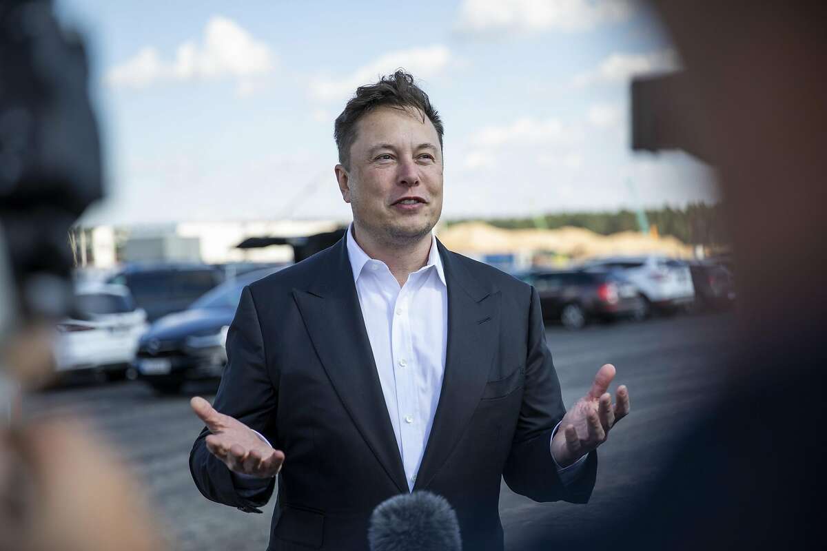 In this file photo, Tesla head Elon Musk talks to the press as he arrives to to have a look at the construction site of the new Tesla Gigafactory near Berlin on September 03, 2020 near Gruenheide, Germany. The Boring Company, Musk's tunneling and infrastructure transportation company, said that it is hiring people in Austin. (Maja Hitij/Getty Images/TNS)
