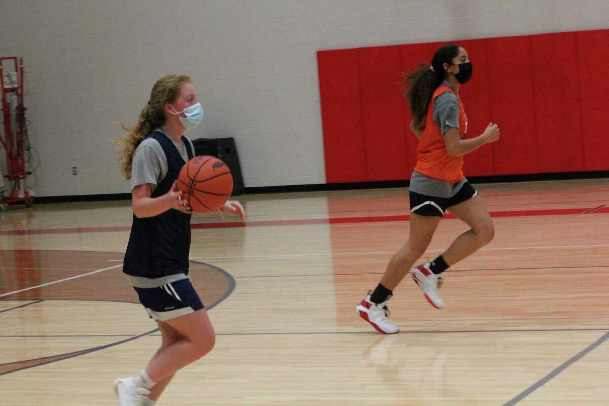 Big Rapids' Ariana Costie (left) brings the ball down the court on Tuesday during a practice in a new auxiliary gymnasium. (Pioneer photo/John Raffel)