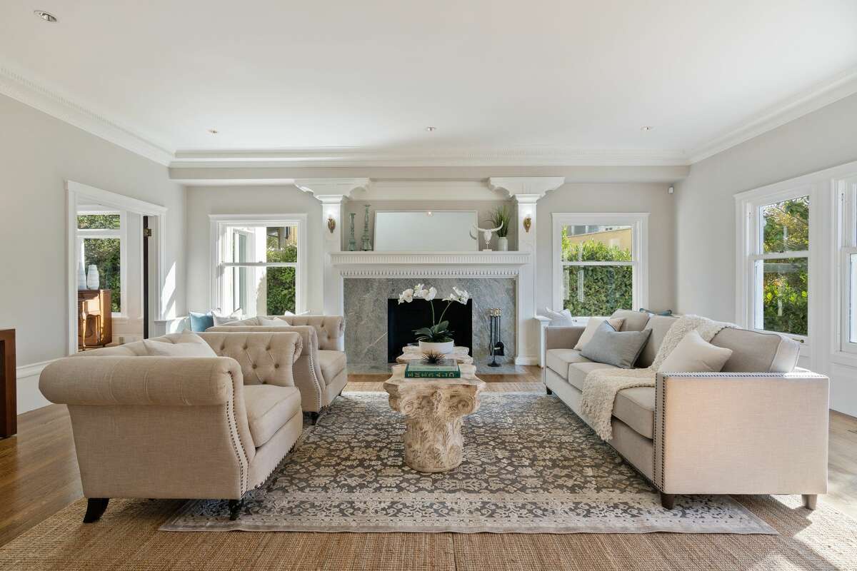 The living room is warmed by natural light and a fireplace. 