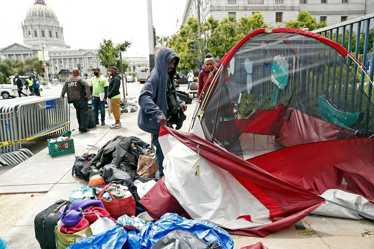 DJ and Ashley Haynes take down their tent on McAllister Street while being relocated to a shelter in place hotel in San Francisco, Calif., on Friday, June 12, 2020.