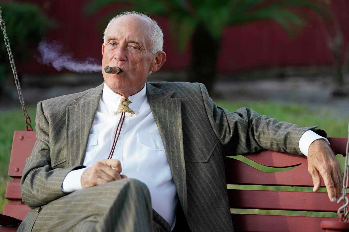 Paul Looney, attorney, smokes a cigar before the start of a media conference outside his home in Austin County on Wednesday, Nov. 11, 2020. His client, Robert Soliz, faces a murder charge in connection with the shooting death of Houston Police Dept. Sgt. Sean Rios. Soliz is accused of killing Rios, who was on his way to work, in a gun battle on Monday afternoon near Interstate 45 service road and Stuebner Airline.