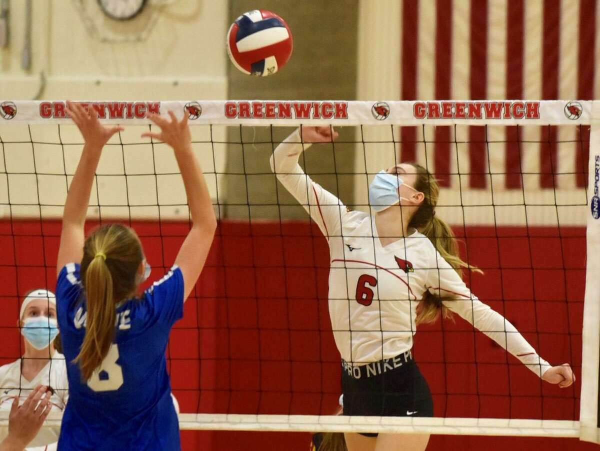 Greenwich’s Adele Sotgiu (6) takes a shot as Darien’s Aubrey Moore (8) defends during the FCIAC West Region volleyball final in Greenwich on Wednesday, Nov. 11, 2020.