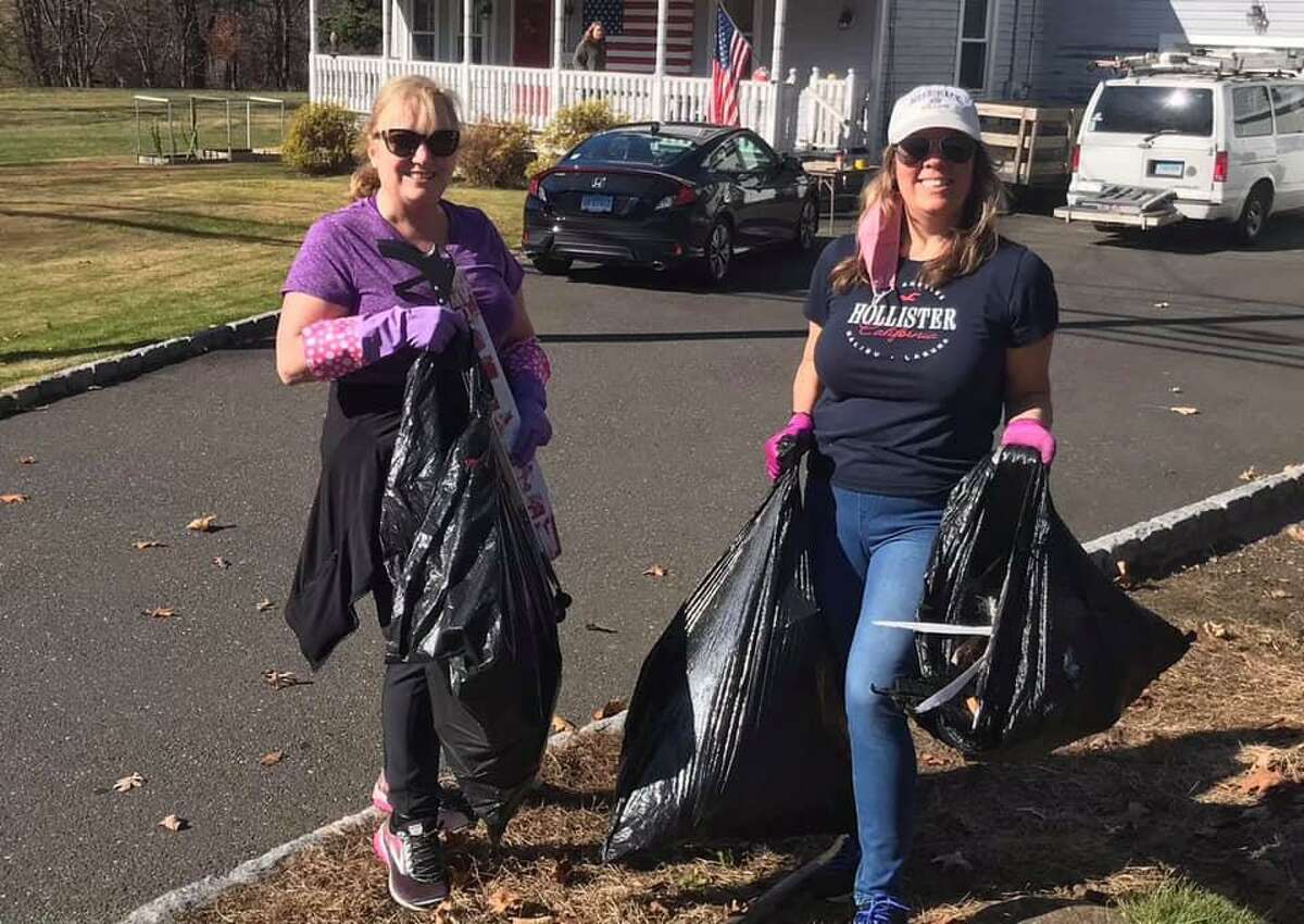 Cindy Nieburh and Julie Howes show off some of the 25 pounds of trash they collected during the Sustainable Trumbull and Save the Sound virtual community cleanup Nov. 8.