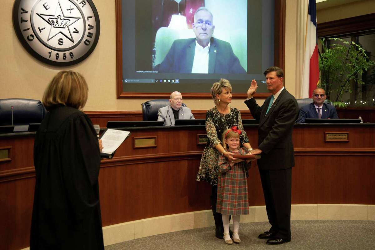 Joe Zimmerman was sworn in for his third term as Sugar Land mayor by Texas Supreme Court Justice Eva Guzman, left.