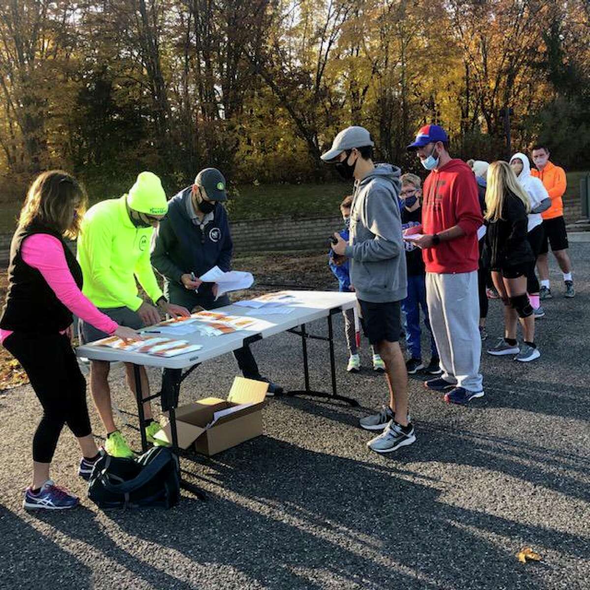 More than 150 runners from the region recently participated in New Milford Fitness and Aquatic Club’s 5k and 10k races at Litchfield Crossings. Above, runners check in at the event.