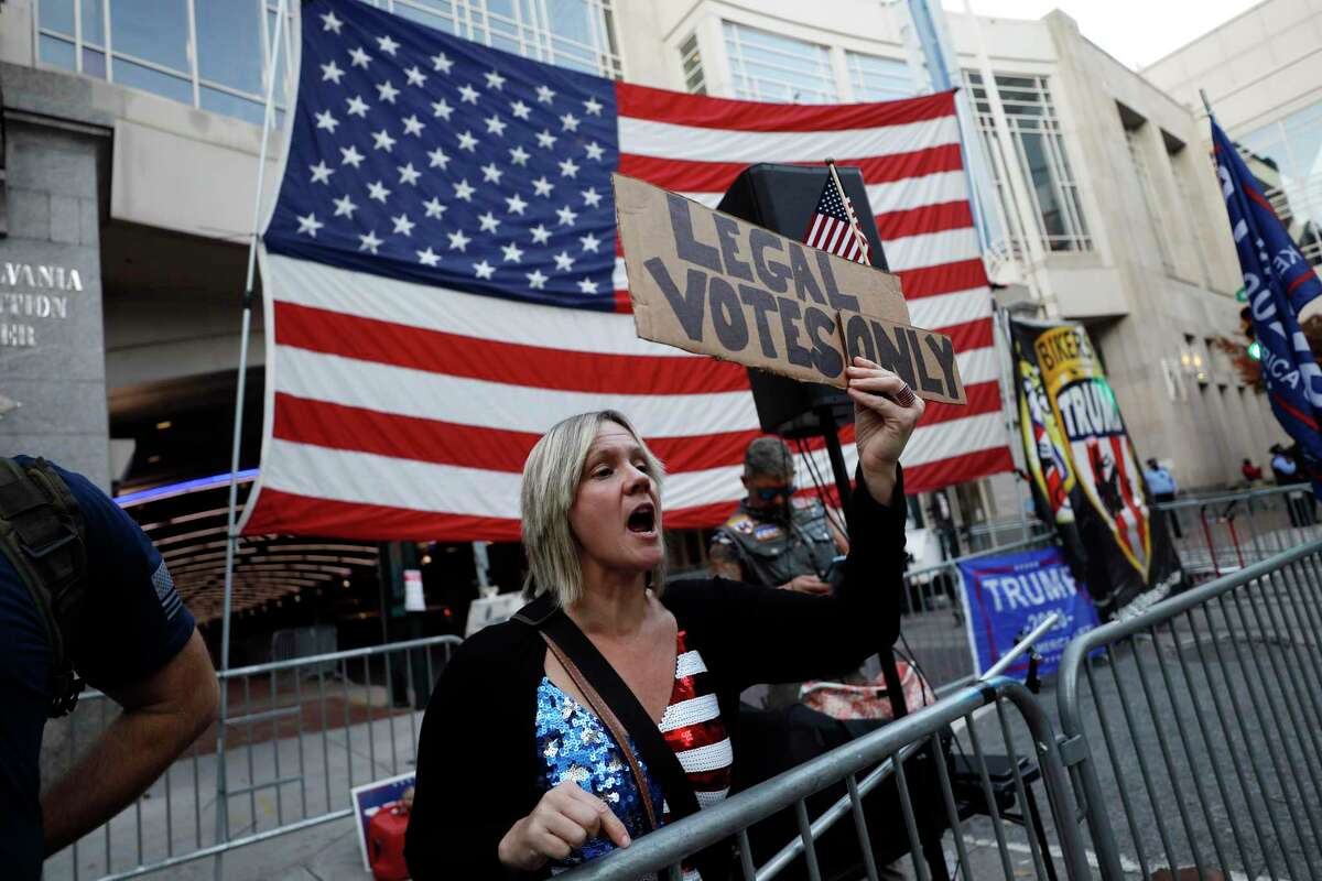 A woman shouts toward supporters of President-elect Joe Biden, as supporters of President Donald Trump protest outside the Pennsylvania Convention Center in Philadelphia, Nov. 8, a day after the 2020 election was called for Democrat Biden.
